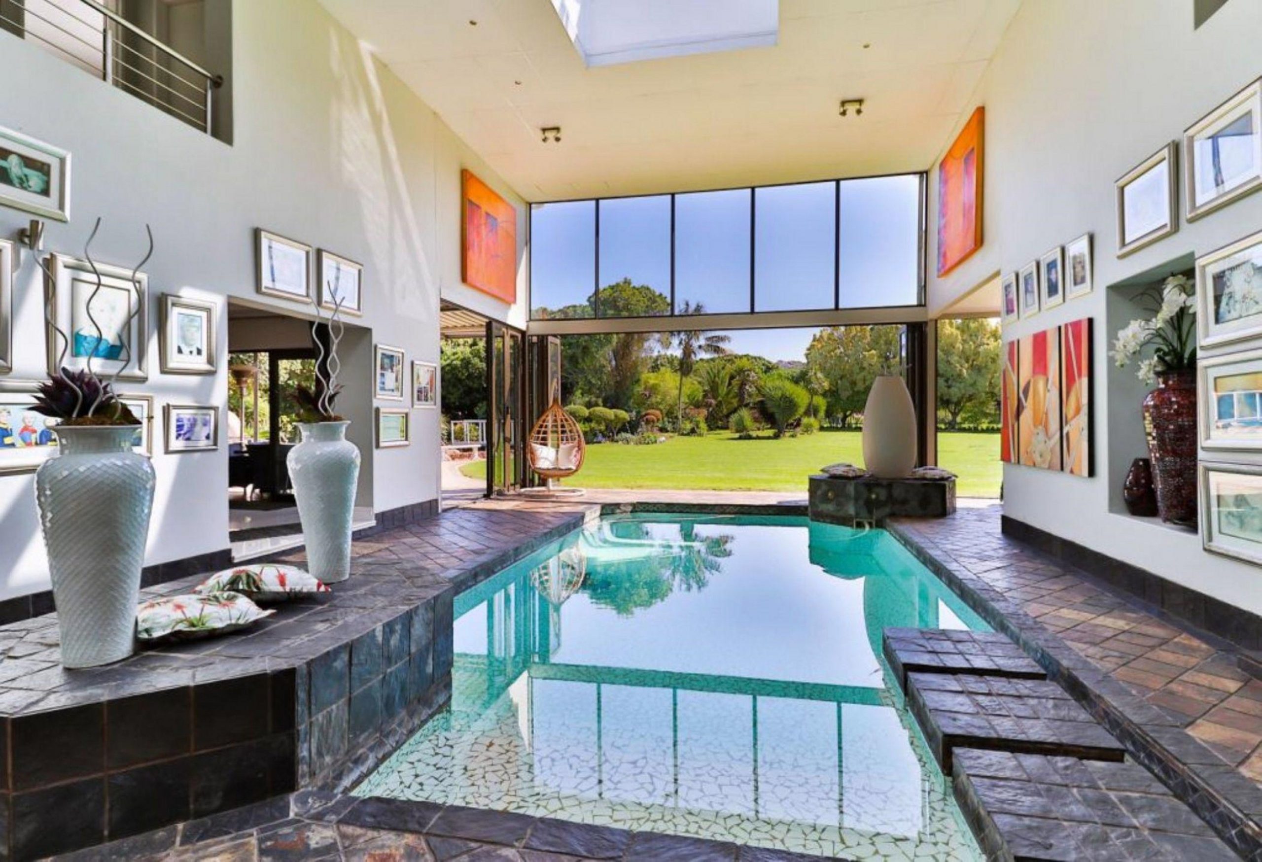This smallholding in Gqeberha was sold by Pam Golding Properties for R9.75 million to a returning expat family. Set among the Milkwood forests of Sardinia Bay and built on two levels, it includes a cinema with state-of-the art surround sound system, Jacuzzi and sauna and large indoor heated swimming pool, gym and squash court, plus four garage, two boreholes, Koi pond and aquaponic greenhouse. This smallholding in Gqeberha was sold by Pam Golding Properties for R9.75 million to a returning expat family. Set among the Milkwood forests of Sardinia Bay and built on two levels, it includes a cinema with state-of-the art surround sound system, Jacuzzi and sauna and large indoor heated swimming pool, gym and squash court, plus four garage, two boreholes, Koi pond and aquaponic greenhouse.