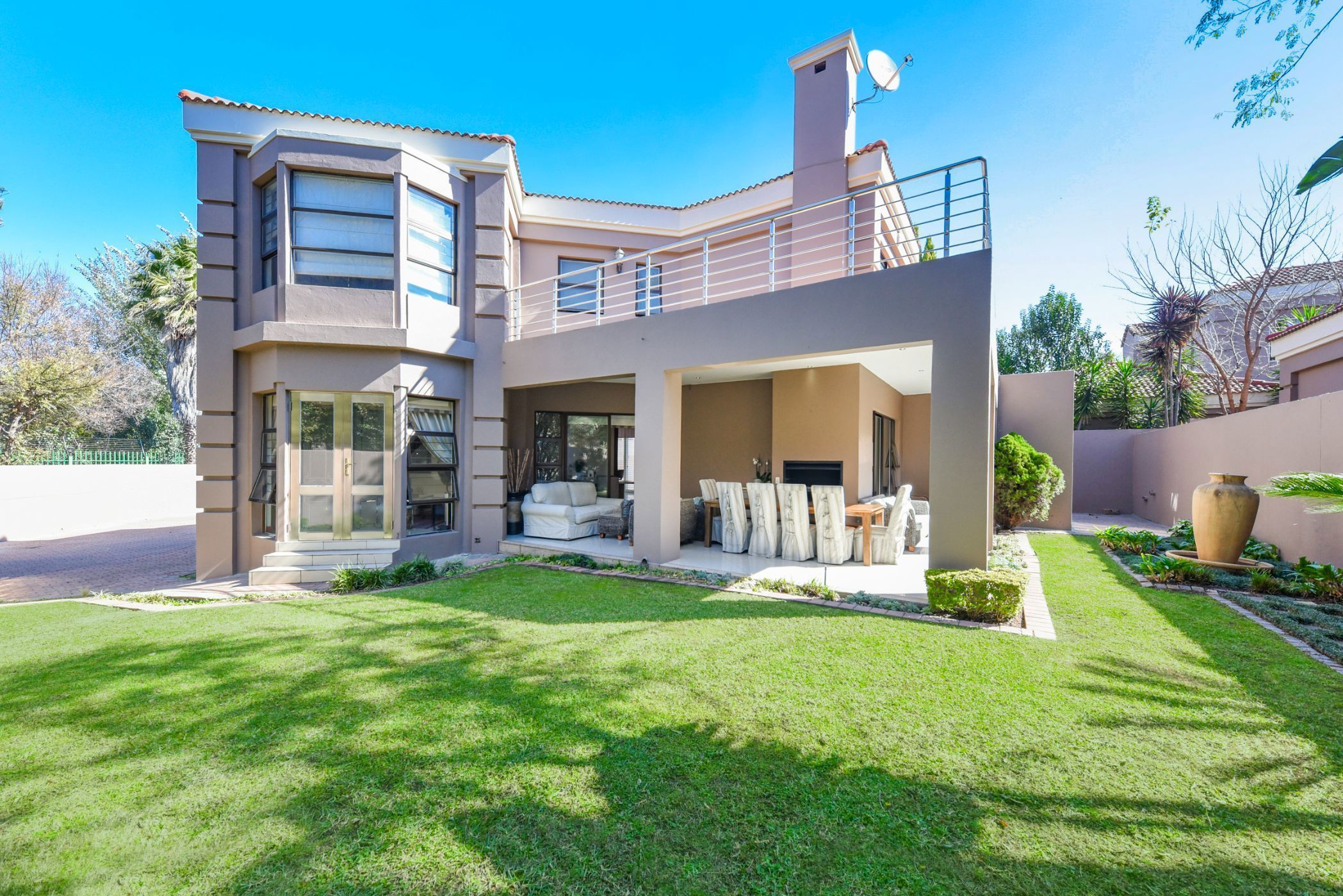 Priced at R3.79 million through Pam Golding Properties, this grand five-bedroom home in an exclusive, secure estate in Craigavon, Fourways, is in proximity to Fourways Mall, Cedar Square, and Crawford International.