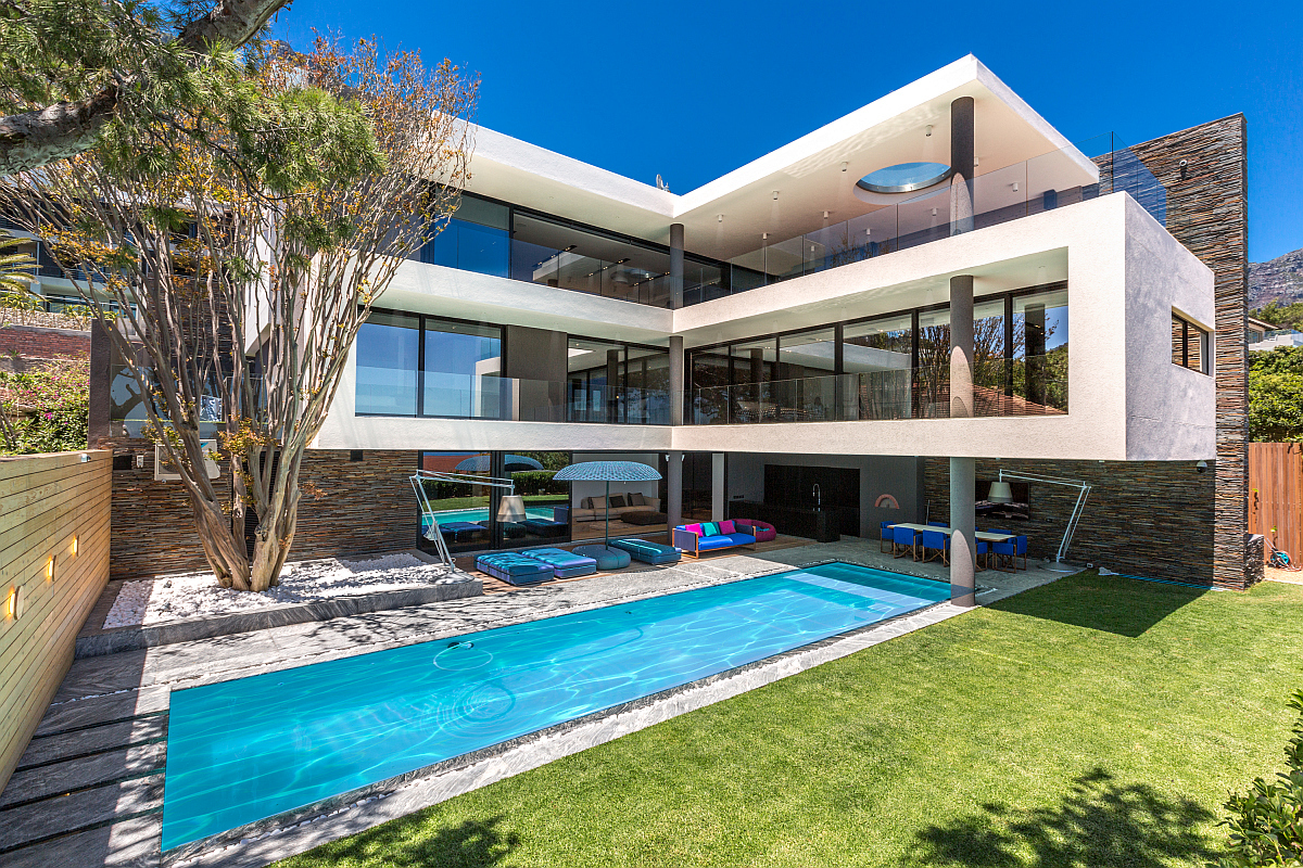 Priced at R115 million (including VAT, no transfer duty) and marketed by Pam Golding Properties, this elegant four-bedroom home in Camps Bay includes a huge outdoor deck with spacious bar area overlooking ocean views, a large swimming pool and cocktail pool on the top floor, and a state-of-the-art cinema, among numerous other features.