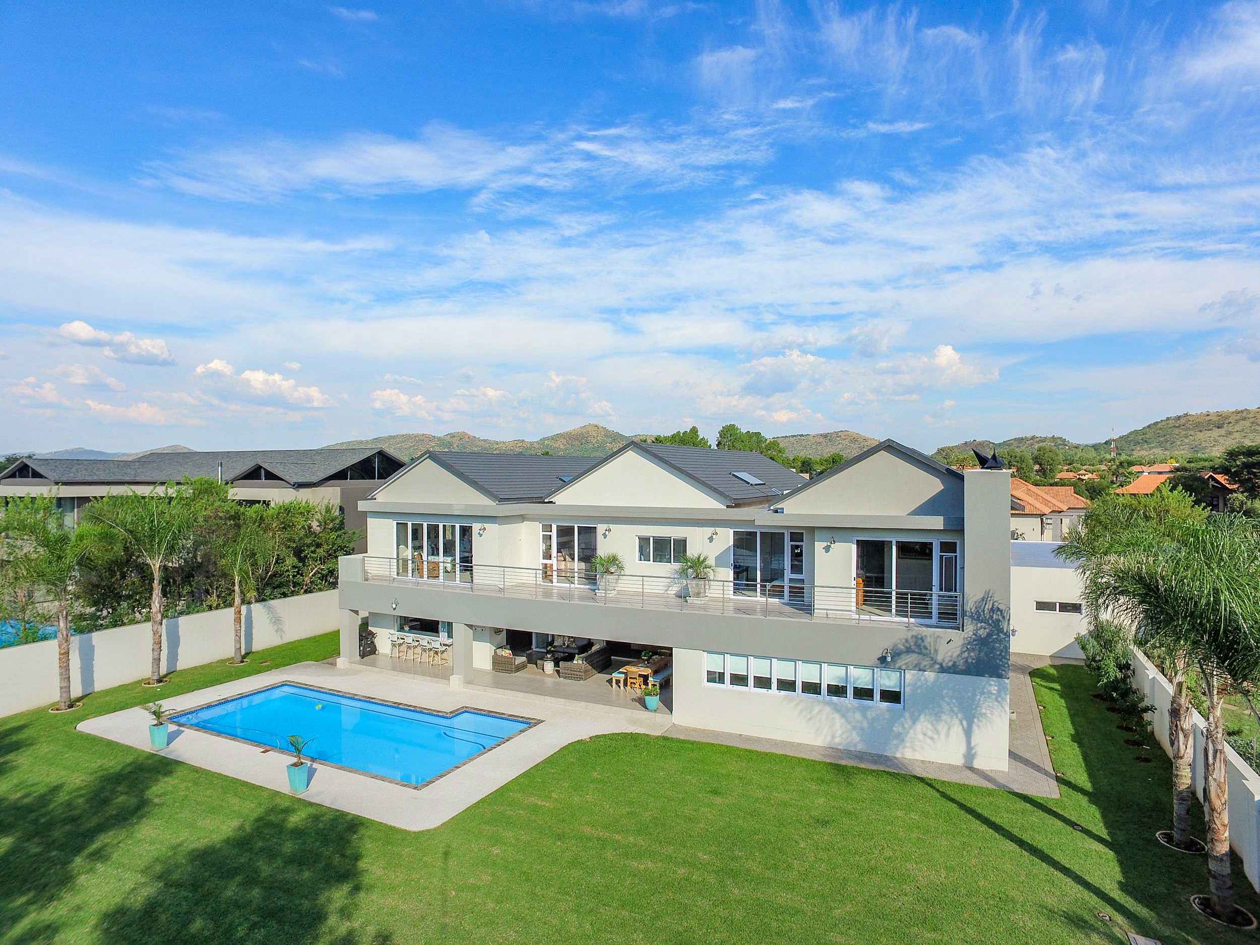 Priced at R14.8 million through Pam Golding Properties, this luxurious five-bedroom home in The Islands Estate in Hartbeespoort includes staff accommodation, cinema room, hobby room, braai room, scullery, laundry and numerous other high-end features such as imported chandeliers, an impressive granite staircase and oak wooden floors. With scenic garden and mountain views, the estate includes a nine-hole mini golf course, streams, fountains, ponds and footpaths as well as an abundance of birdlife. Priced at R14.8 million through Pam Golding Properties, this luxurious five-bedroom home in The Islands Estate in Hartbeespoort includes staff accommodation, cinema room, hobby room, braai room, scullery, laundry and numerous other high-end features such as imported chandeliers, an impressive granite staircase and oak wooden floors. With scenic garden and mountain views, the estate includes a nine-hole mini golf course, streams, fountains, ponds and footpaths as well as an abundance of birdlife.