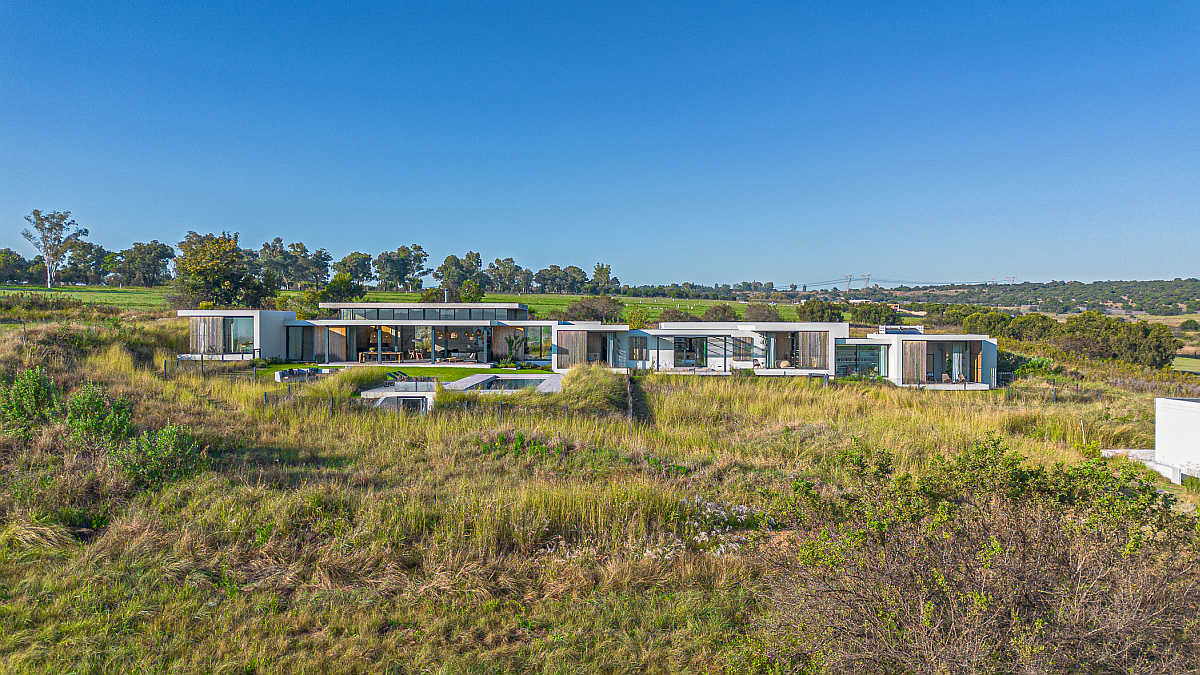 Marketed by Pam Golding Properties at R24 million, this expansive north-facing, single-storey modern farmhouse in Monaghan Farm, Gauteng, is set on 6184sqm amid natural grasslands with sweeping views. Offering 750sqm of living space, the home combines clean architectural lines with natural materials and includes seven bedrooms, 7.5 bathrooms, three parking bays, underfloor heating, a vegetable garden, fire pit, solar panels, inverters, solar geysers, an underground municipal water tank and double-glazed windows. 