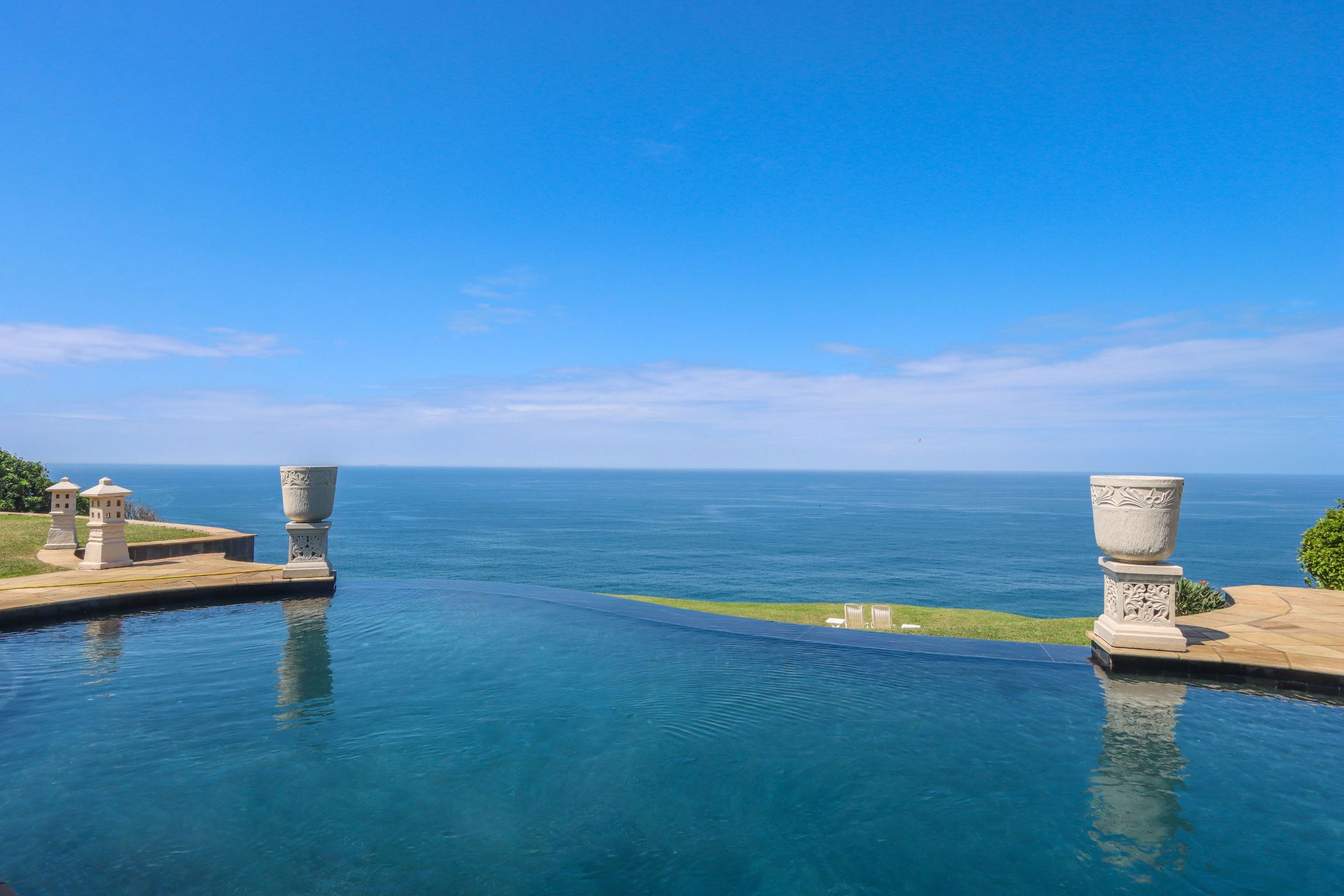 Priced at R24 million through Pam Golding Properties, this sophisticated and luxurious Mediterranean-style residence in a tranquil location in Amanzimtoti, with panoramic ocean views includes four bedrooms, five bathrooms, and is ideal as an exclusive private residence or guest retreat.