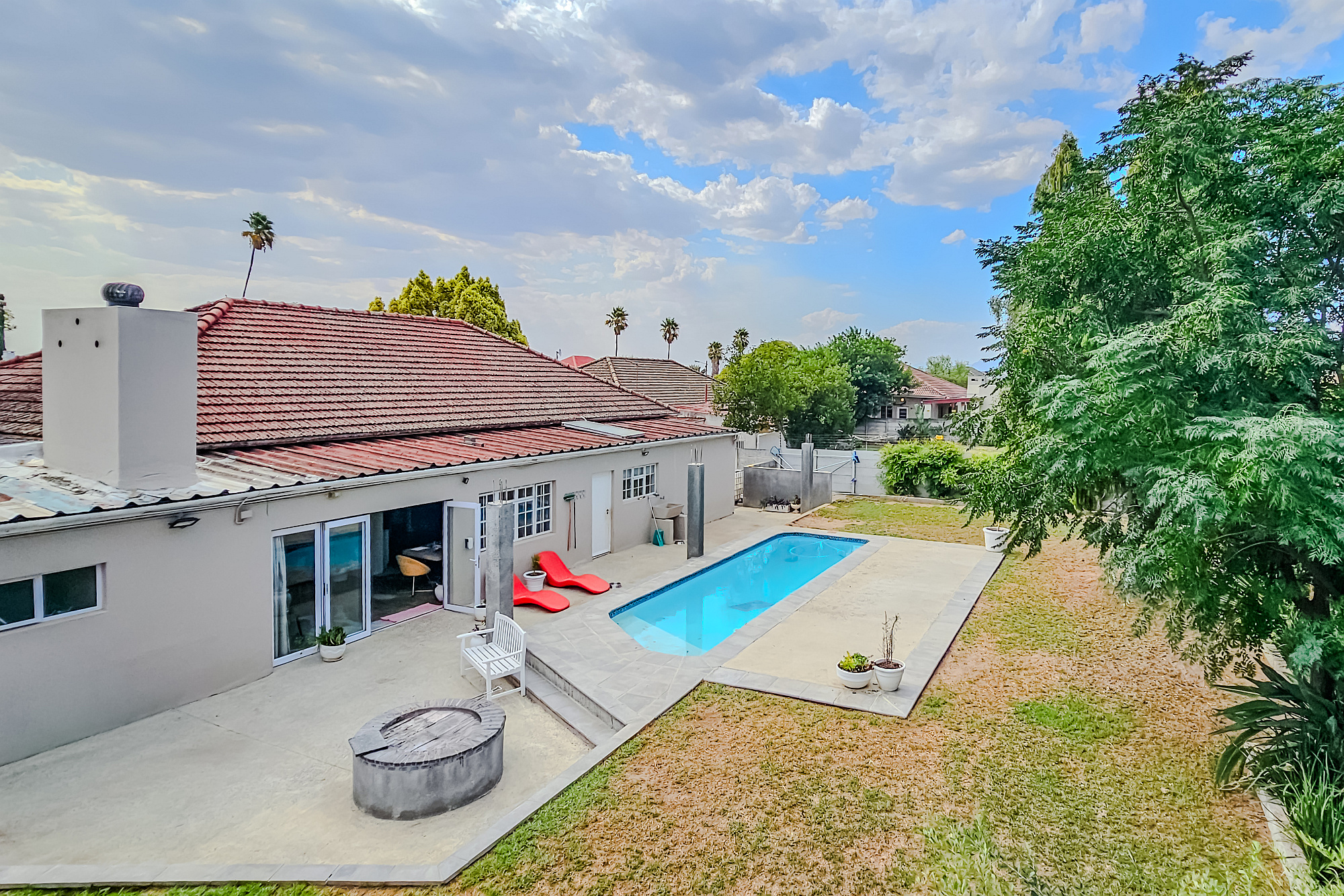 Set on a large corner plot in Wellington, this four-bedroom, three-bathroom home offers generous indoor and outdoor spaces, ideal for relaxed family living and entertaining. Priced at R3.499 million through Pam Golding Properties, the property includes a spacious flatlet with a bedroom, bathroom, lounge, and kitchen, air conditioning, swimming pool, patio currently being developed into a covered entertainment area, outside storeroom, 70sqm garage, four water tanks and ample off-street parking. 