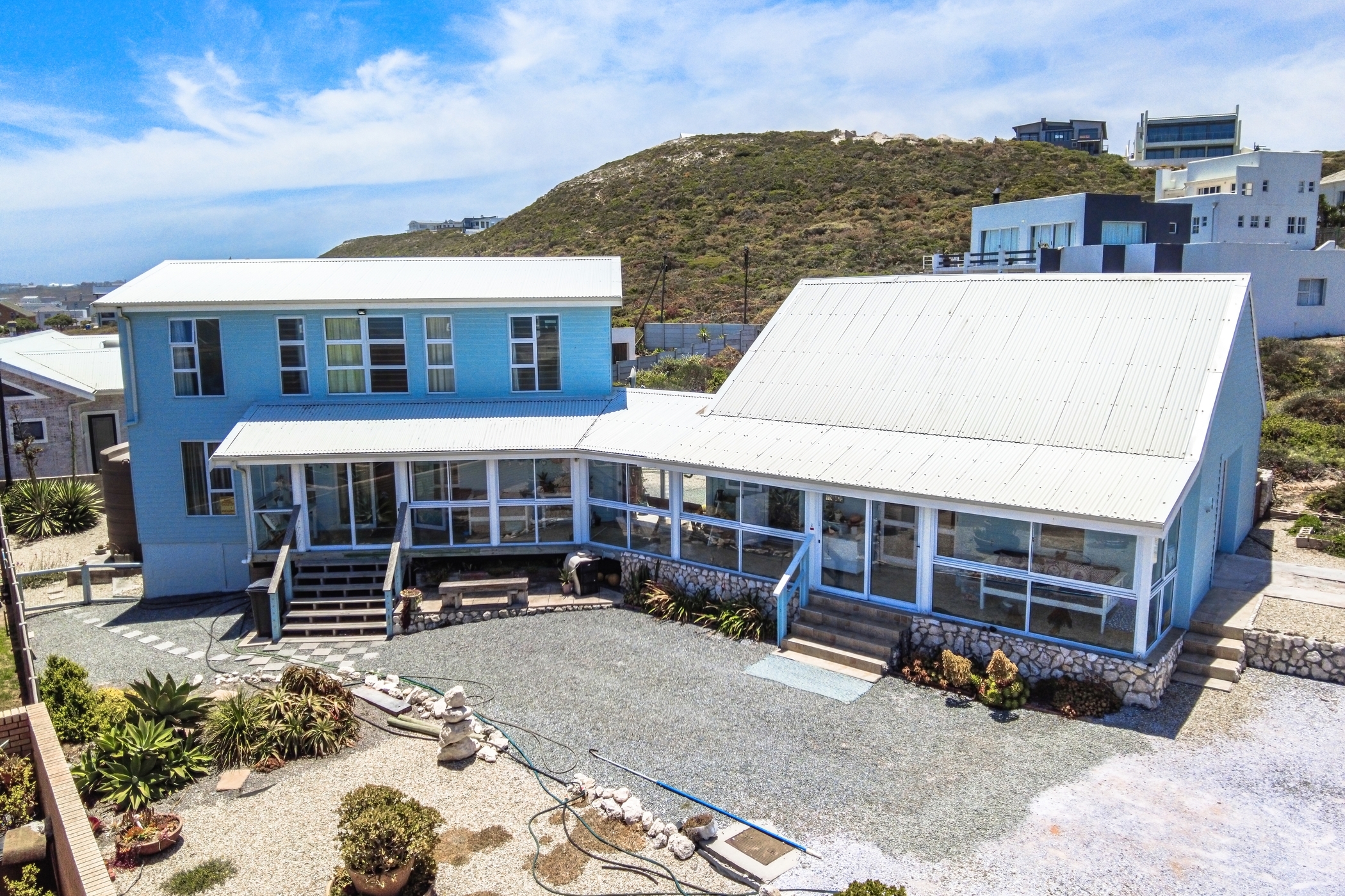 Priced at R5.5 million through Pam Golding Properties, this appealing and well-maintained three-bedroom, three-bathroom house in Yzerfontein is an ideal lock-up-and-go holiday home, well-positioned just one road from the ocean. A spacious open plan living /dining room and kitchen is the central hub of the home, while the enclosed verandah running the length of the house enjoys sweeping sea views. The third bedroom has its own entrance and could be used to generate extra income.