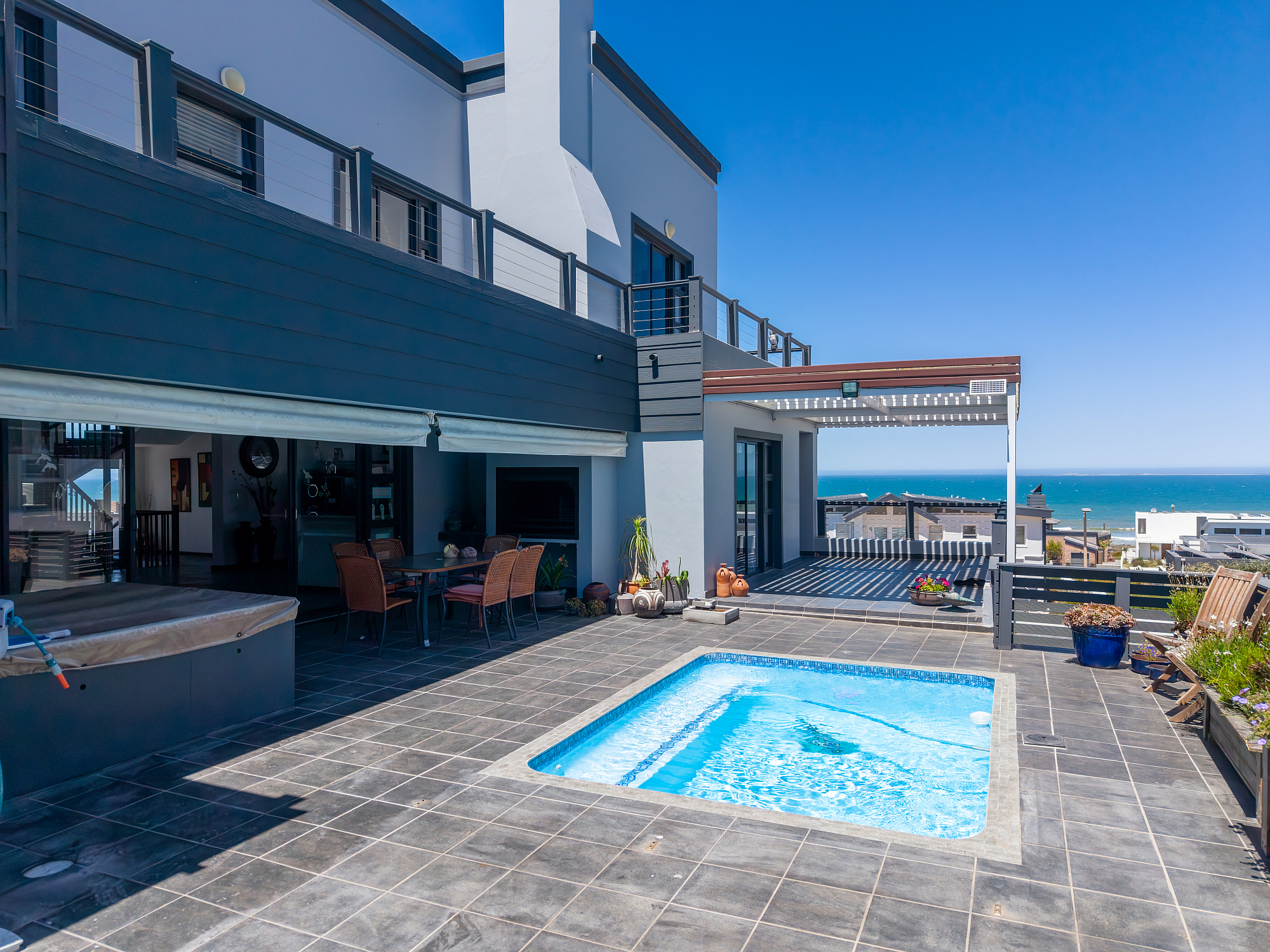 With four bedrooms and 4.5 bathrooms, this spacious and modern double-storey home in Yzerfontein’s Pearl Bay is ideally situated between an untouched fynbos greenbelt and the endless Atlantic horizon, providing privacy, space and uninterrupted sea views. Priced at R9.25 million through Pam Golding Properties, the property includes a backup power system — including solar panels, a Deye inverter and battery storage, a security system and 24-hour armed response.