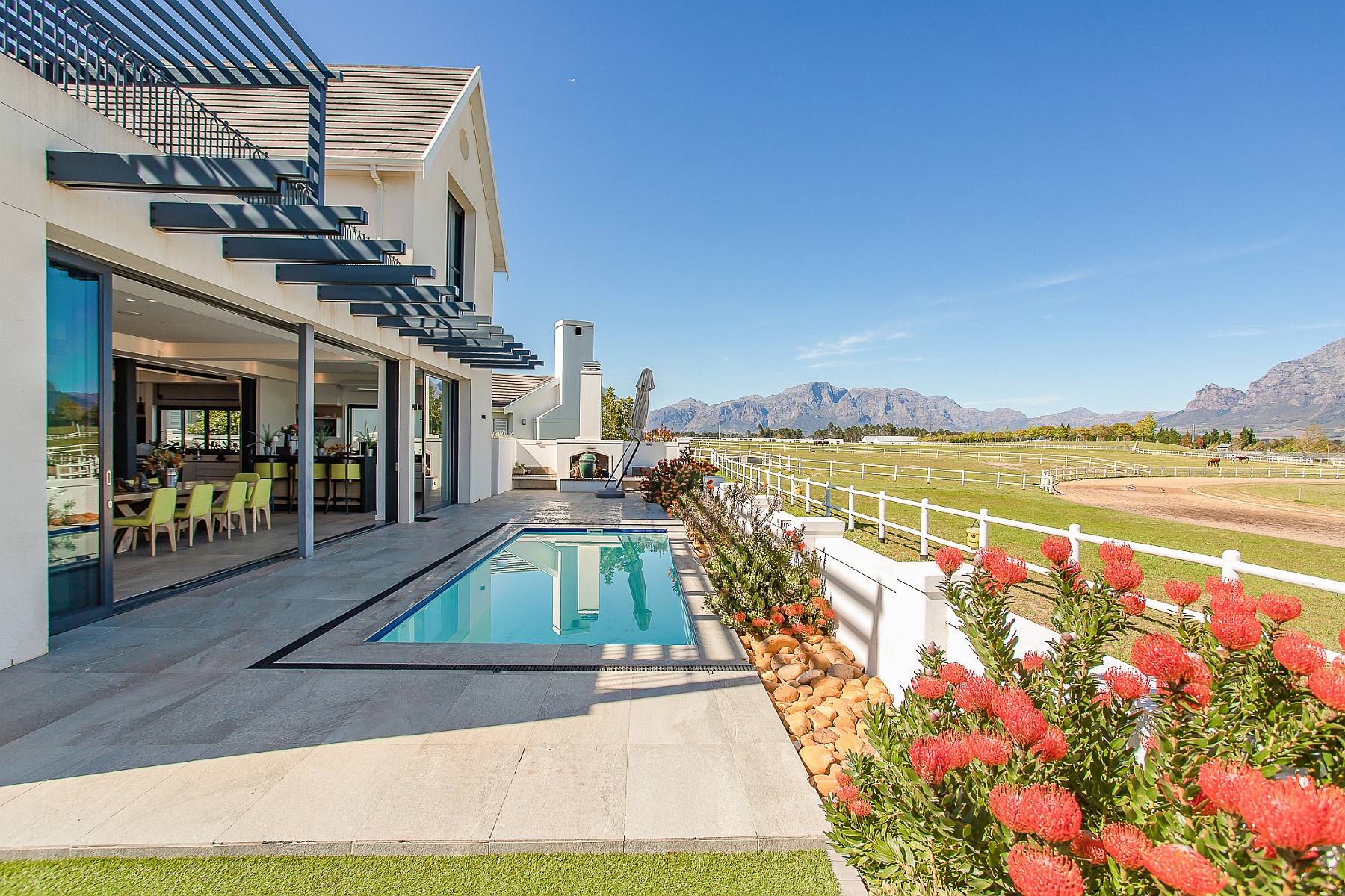 Priced at R16.9 million through Pam Golding Properties, this luxury four-bedroom family home in the secure Val de Vie estate in Paarl has spectacular views across the polo fields to majestic mountain ranges. It includes a granny flat with its own entrance and private garden.