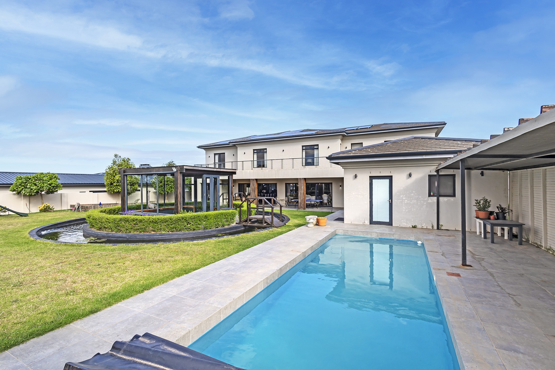 This sprawling and immaculate, seven-bedroom family home in Clara Anna Fontein Lifestyle Estate includes a guest suite and staff accommodation. The perfect ‘canvas’ on which to imprint your own individual tastes and lifestyle preferences, this modern masterpiece is priced at R21.995 million through Pam Golding Properties. A lush garden and sparkling swimming pool complete the picture. This sprawling and immaculate, seven-bedroom family home in Clara Anna Fontein Lifestyle Estate includes a guest suite and staff accommodation. The perfect ‘canvas’ on which to imprint your own individual tastes and lifestyle preferences, this modern masterpiece is priced at R21.995 million through Pam Golding Properties. A lush garden and sparkling swimming pool complete the picture.